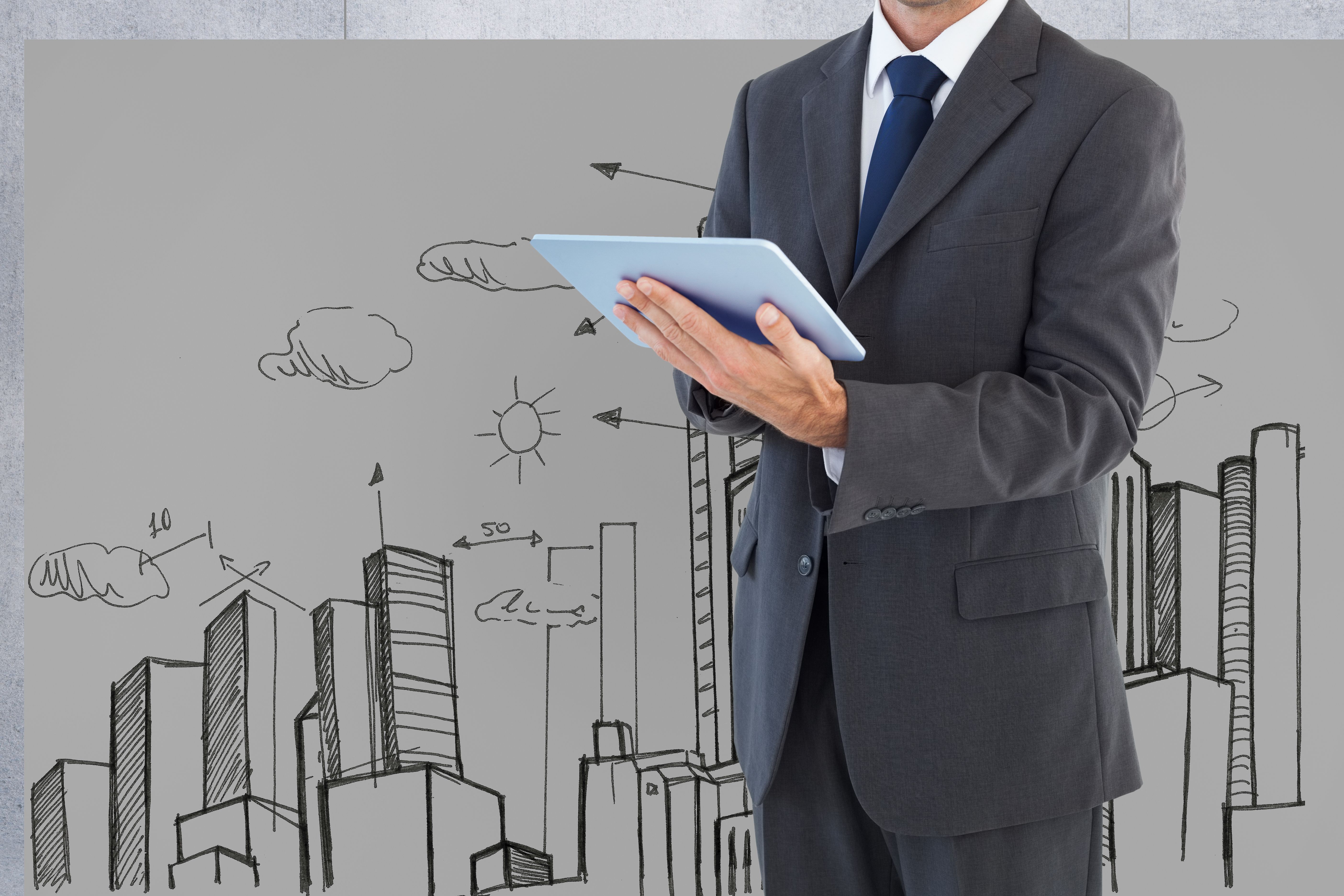 man-suit-with-tablet-background-city-drawn.jpg